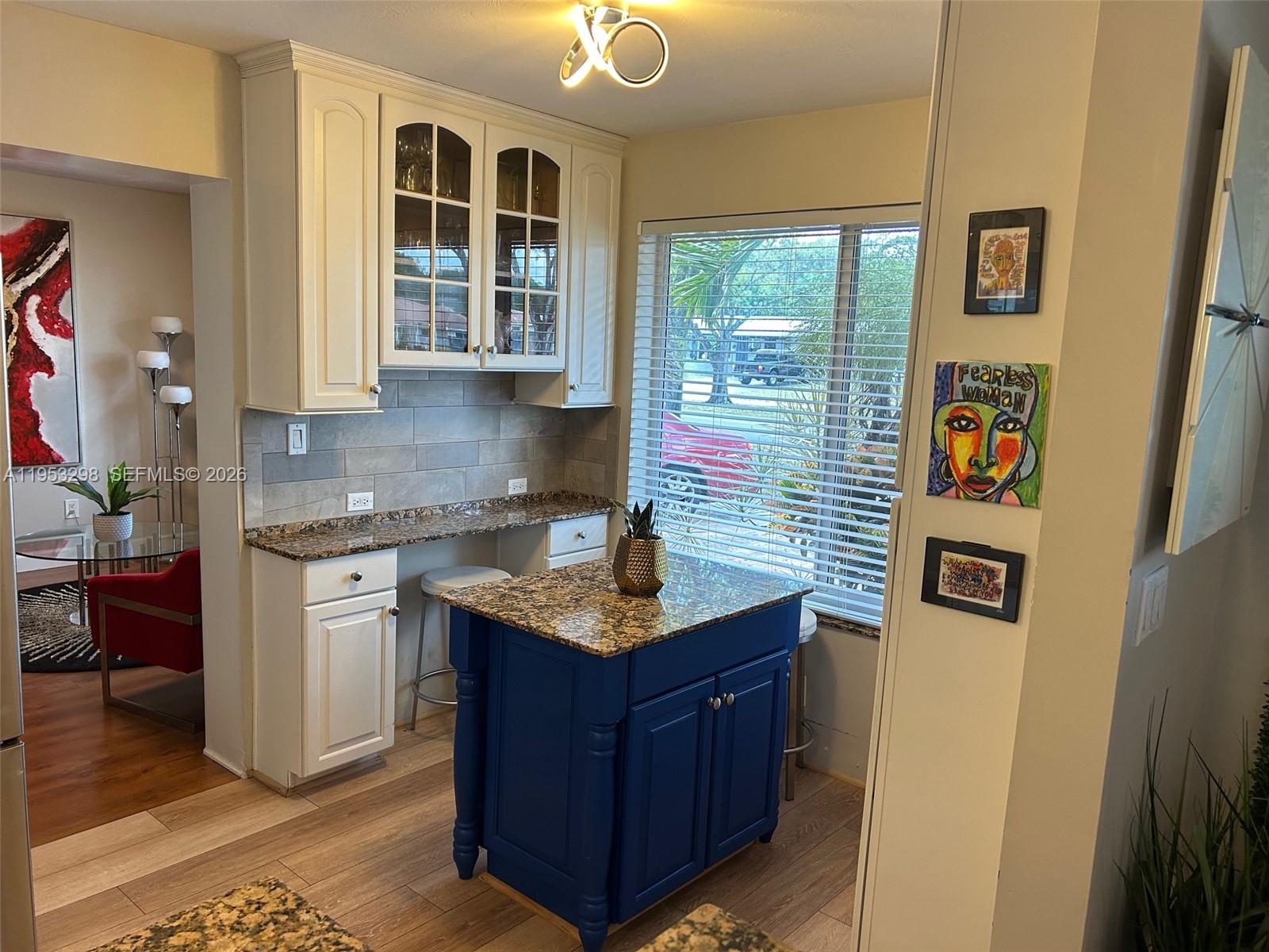 262 Southwest 54th Avenue Plantation, FL 33317 - Photo 13 of 16 a kitchen with stainless steel appliances granite countertop a stove a sink and a refrigerator