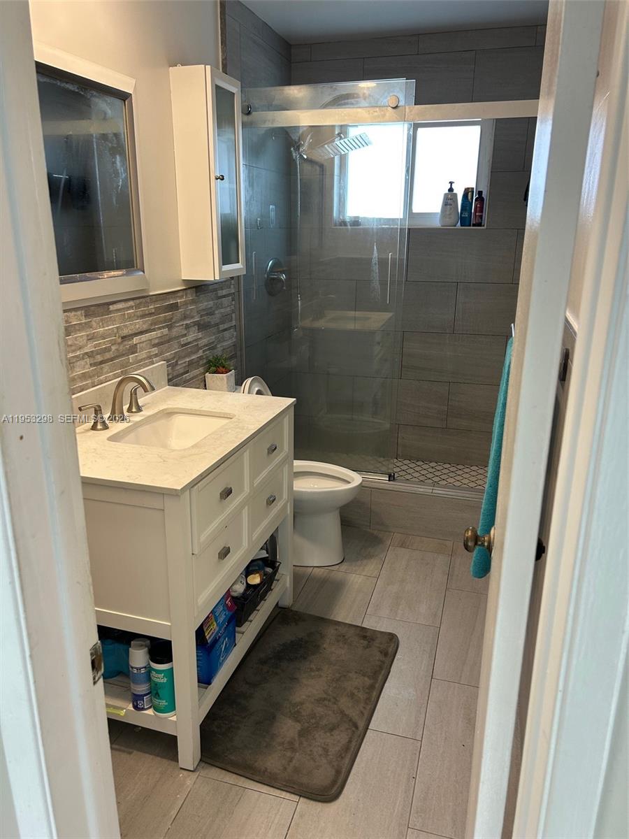 262 Southwest 54th Avenue Plantation, FL 33317 - Photo 3 of 16 a bathroom with a sink a toilet and shower