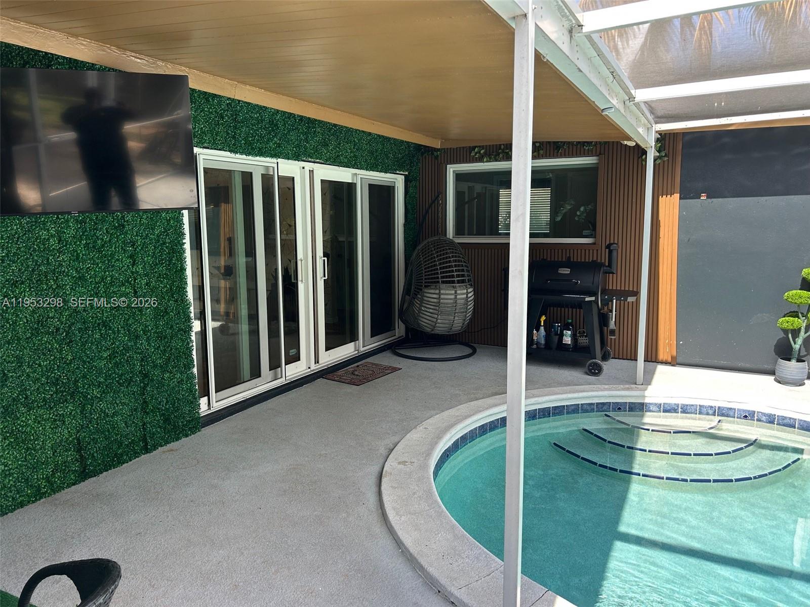 262 Southwest 54th Avenue Plantation, FL 33317 - Photo 5 of 16 a view of a livingroom with a patio and fire pit