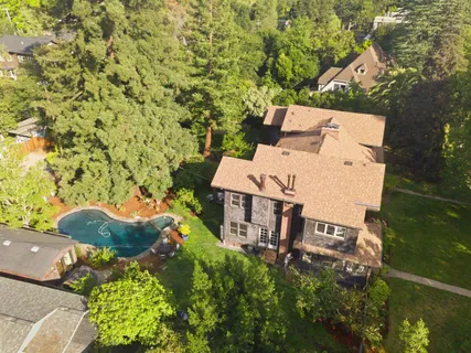 an aerial view of a house with yard and outdoor seating