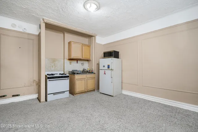 a kitchen with a refrigerator and a stove