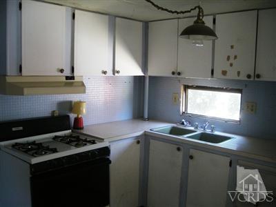 4381 Cochran Street, Unit 6 Simi Valley, CA 93063 - Photo 3 of 8 a kitchen with granite countertop a stove and a sink