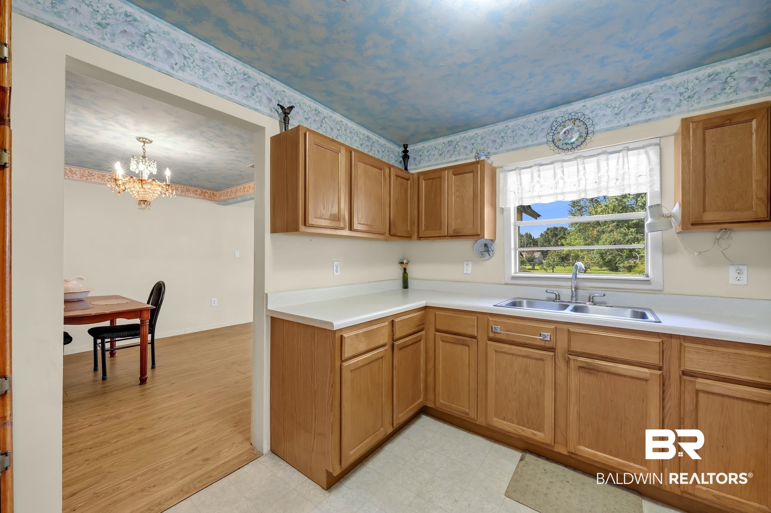 304 West Myrtle Avenue Foley, AL 36535 - Photo 9 of 29 Corner kitchen featuring light wood-finish cabinetry and white countertops