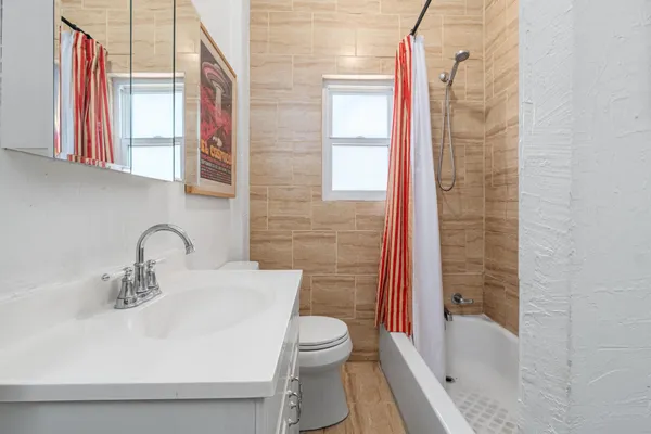 a bathroom with a sink toilet and shower