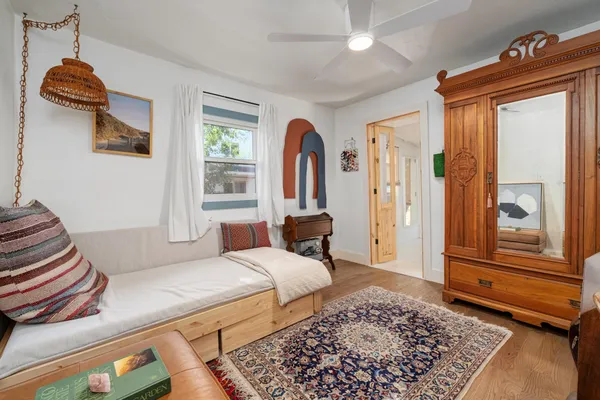 a bedroom with a bed and wooden floor