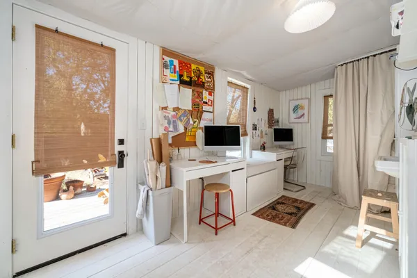 a view of living room filled with furniture and large window
