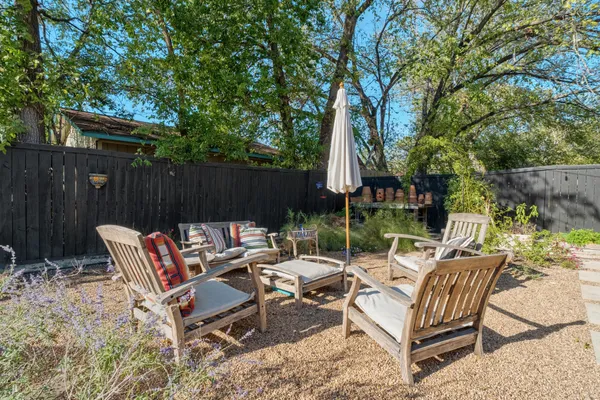 a view of backyard with outdoor seating and trees