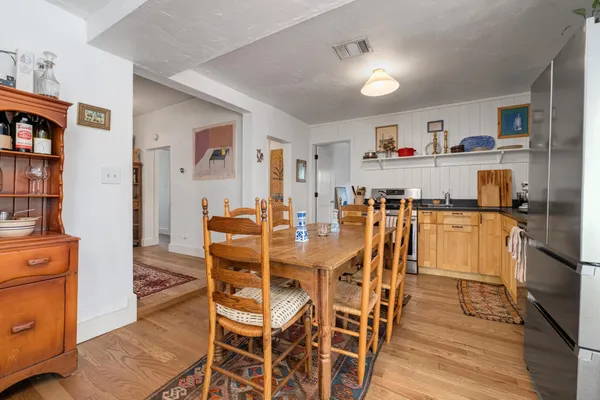 a dining room with furniture and wooden floor