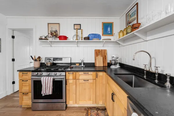 a kitchen with stainless steel appliances granite countertop a sink and cabinets