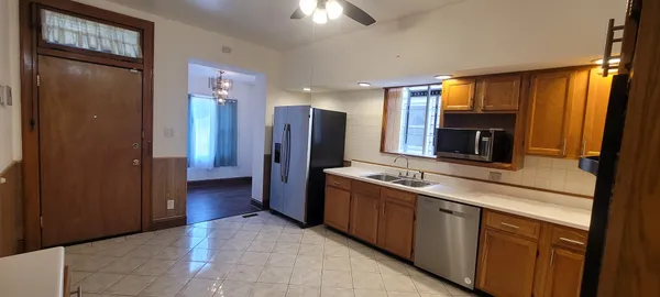 a kitchen with stainless steel appliances granite countertop a refrigerator and a sink