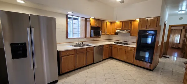 a kitchen with stainless steel appliances granite countertop a refrigerator and a sink
