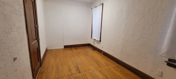 a view of a room with wooden floor