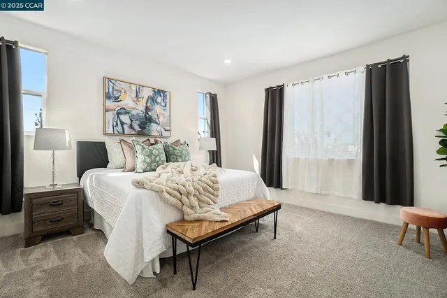 a spacious bedroom with a bed and a window