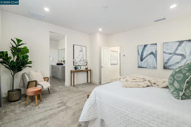 a bedroom with a bed and a couch