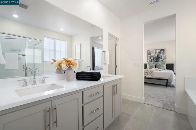 a en suite bathroom with double sink and a mirror