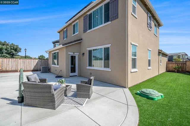 a outdoor space with patio couches and a fireplace with wooden floor