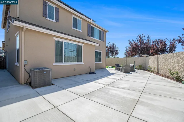 a view of a house with backyard and sitting area
