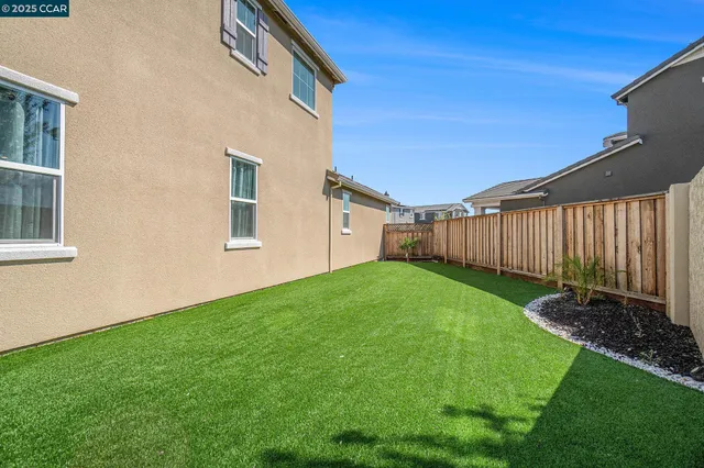 a backyard of a house with lots of green space