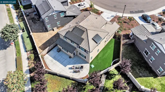 an aerial view of a house with a yard
