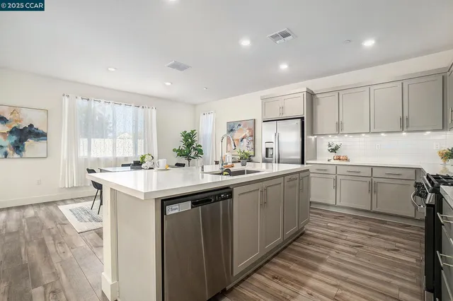 a kitchen with a sink window and cabinets
