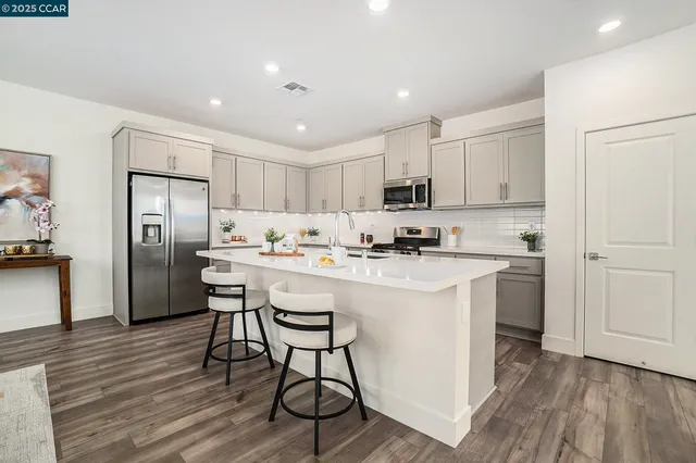 a kitchen with stainless steel appliances a refrigerator stove microwave and cabinets