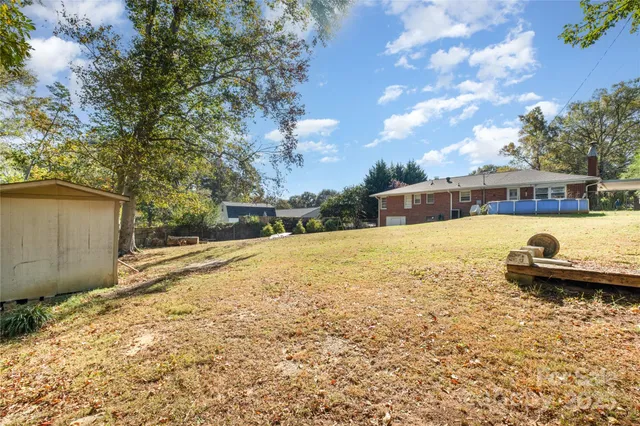 a view of a swimming pool with a yard