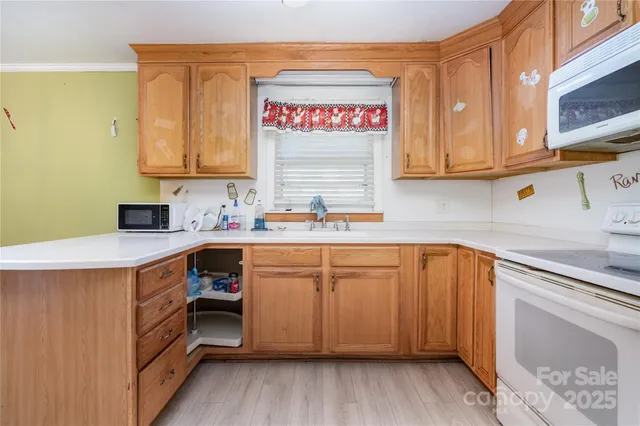 a kitchen with stainless steel appliances granite countertop a sink stove and cabinets