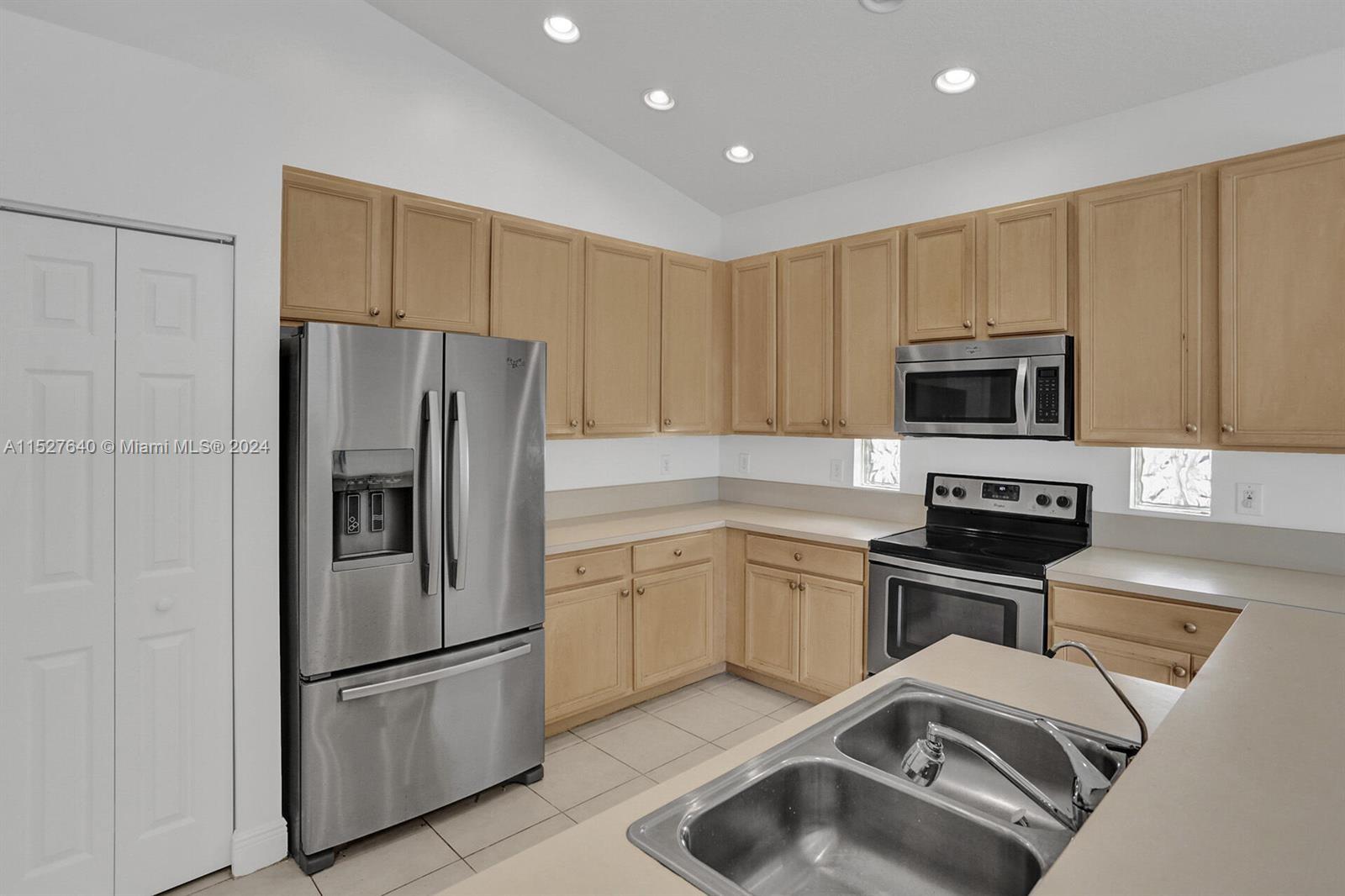 6553 Spring Meadow Drive Greenacres, FL 33413 - Photo 6 of 10 a kitchen with a refrigerator sink and microwave