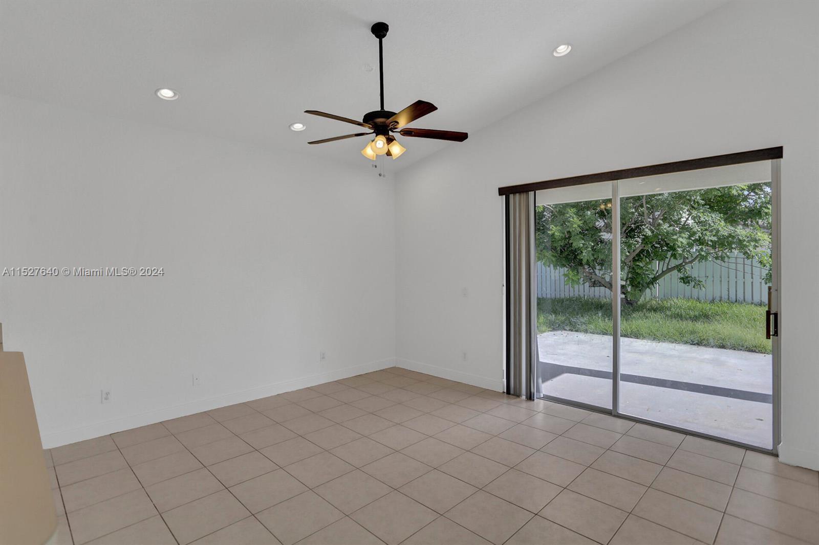 6553 Spring Meadow Drive Greenacres, FL 33413 - Photo 9 of 10 a view of empty room with windows