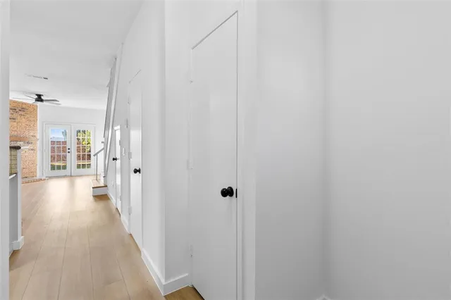 a view of a hallway with wooden floor