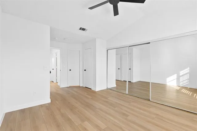 a view of empty room with wooden floor