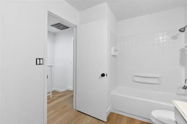 a bathroom with a toilet and a bathtub