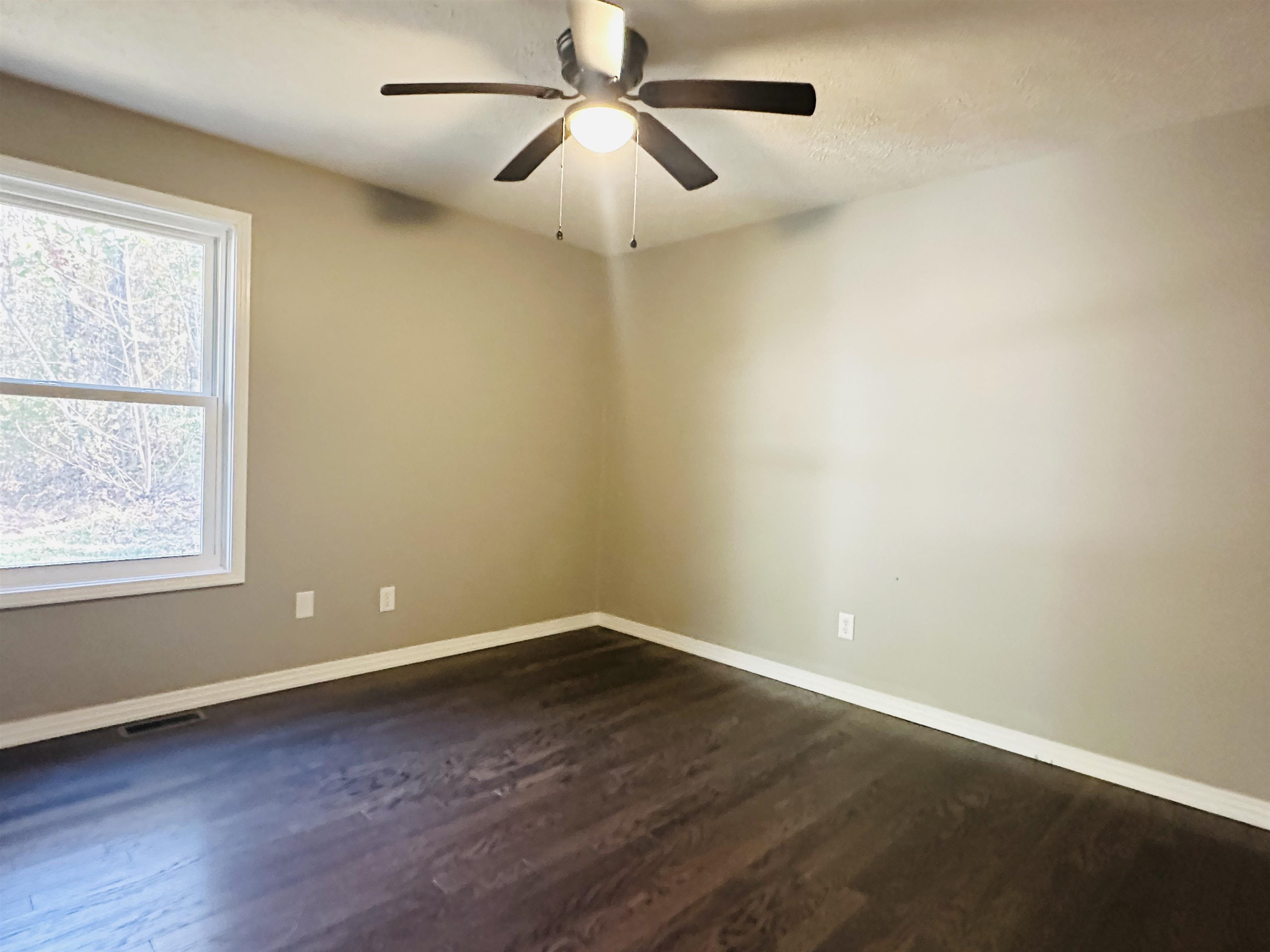 623 Bethesda-Purdy Road Selmer, TN 38375 - Photo 11 of 19 Spare room featuring ceiling fan and dark hardwood / wood-style flooring
