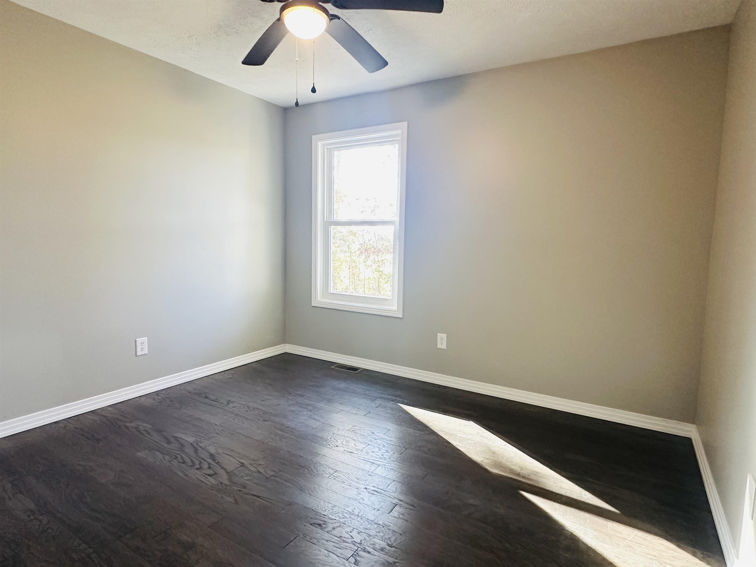 623 Bethesda-Purdy Road Selmer, TN 38375 - Photo 13 of 19 Unfurnished room with ceiling fan and dark hardwood / wood-style flooring