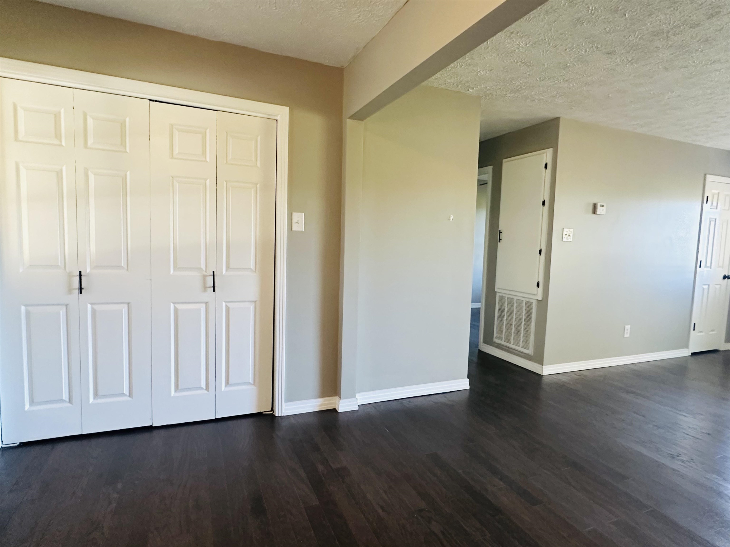 623 Bethesda-Purdy Road Selmer, TN 38375 - Photo 10 of 19 Interior space with dark hardwood / wood-style floors and a textured ceiling