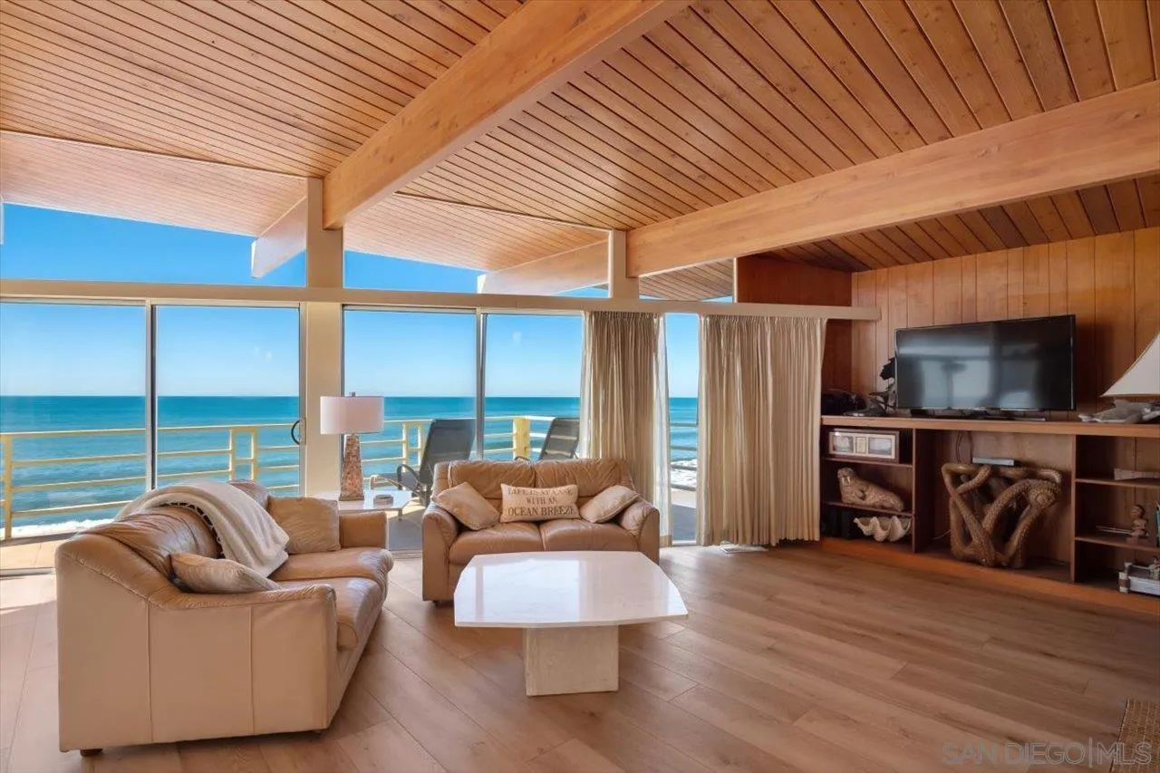 2681 Ocean Street Carlsbad, CA 92008 - Photo 1 of 36 a living room with furniture and a floor to ceiling window