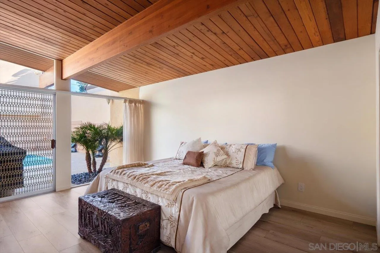 2681 Ocean Street Carlsbad, CA 92008 - Photo 11 of 36 a bedroom with a bed and a potted plant