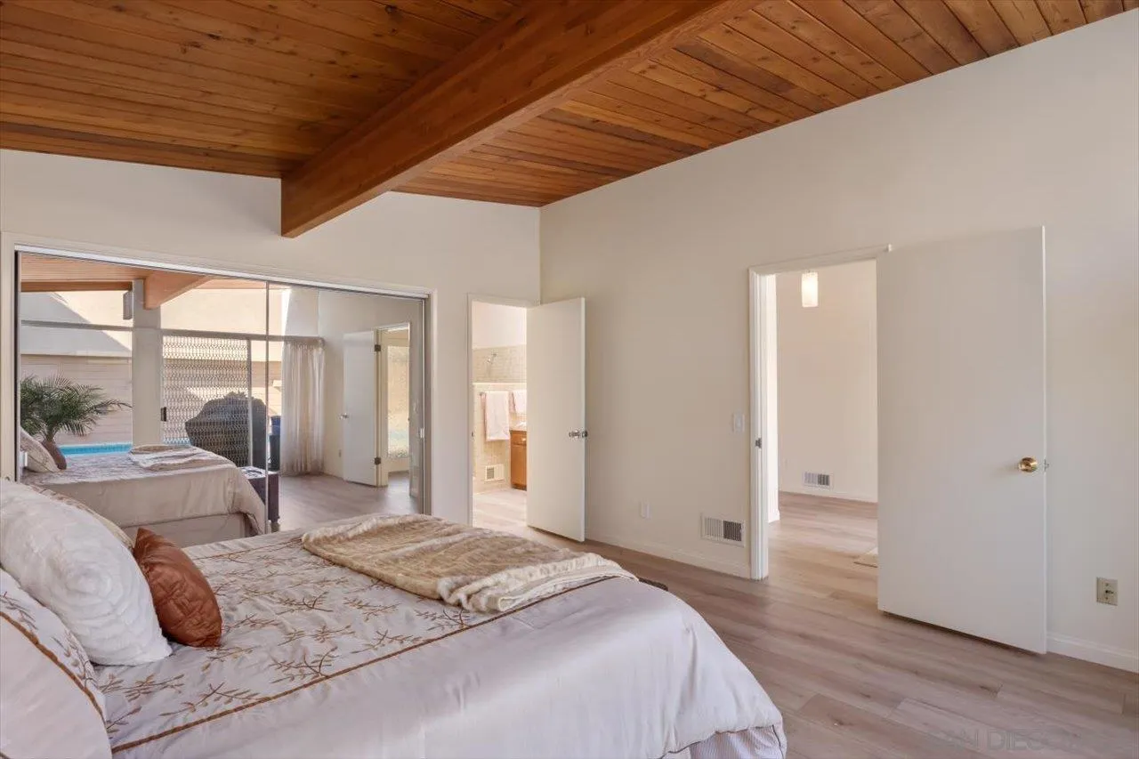 2681 Ocean Street Carlsbad, CA 92008 - Photo 12 of 36 a bedroom with a bed mirror and window