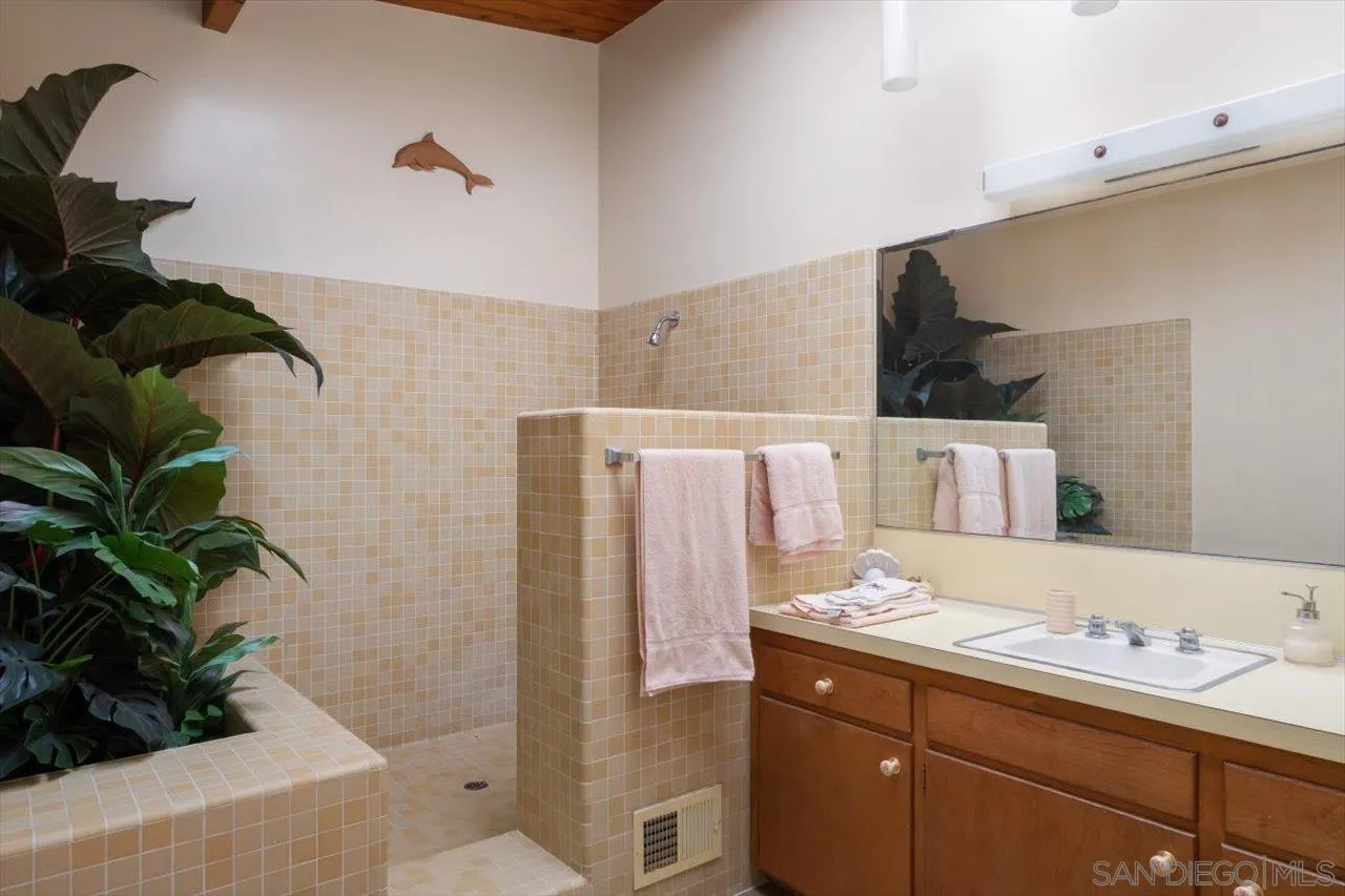 2681 Ocean Street Carlsbad, CA 92008 - Photo 14 of 36 a bathroom with a double vanity sink and a mirror
