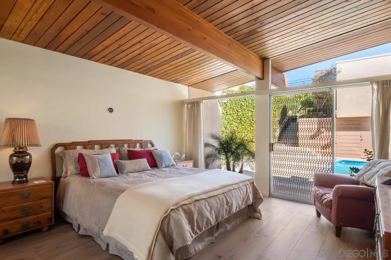 2681 Ocean Street Carlsbad, CA 92008 - Photo 15 of 36 a bedroom with a bed and a large window