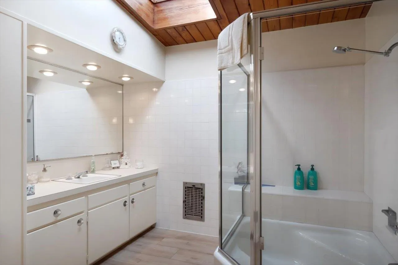 2681 Ocean Street Carlsbad, CA 92008 - Photo 17 of 36 a bathroom with a double vanity sink mirror and shower