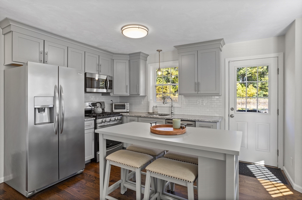 45 Riley Road, Unit 45 Tyngsborough, MA 01879 - Photo 11 of 42 a kitchen with a refrigerator a stove a sink and a window