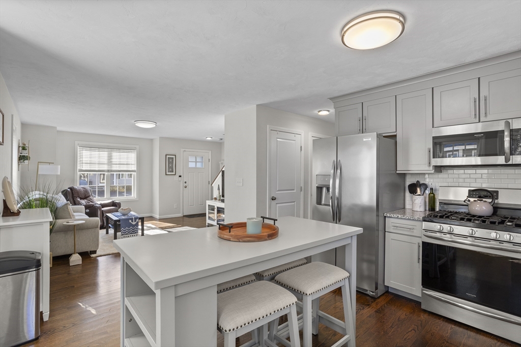 45 Riley Road, Unit 45 Tyngsborough, MA 01879 - Photo 13 of 42 a kitchen with a dining table and chairs