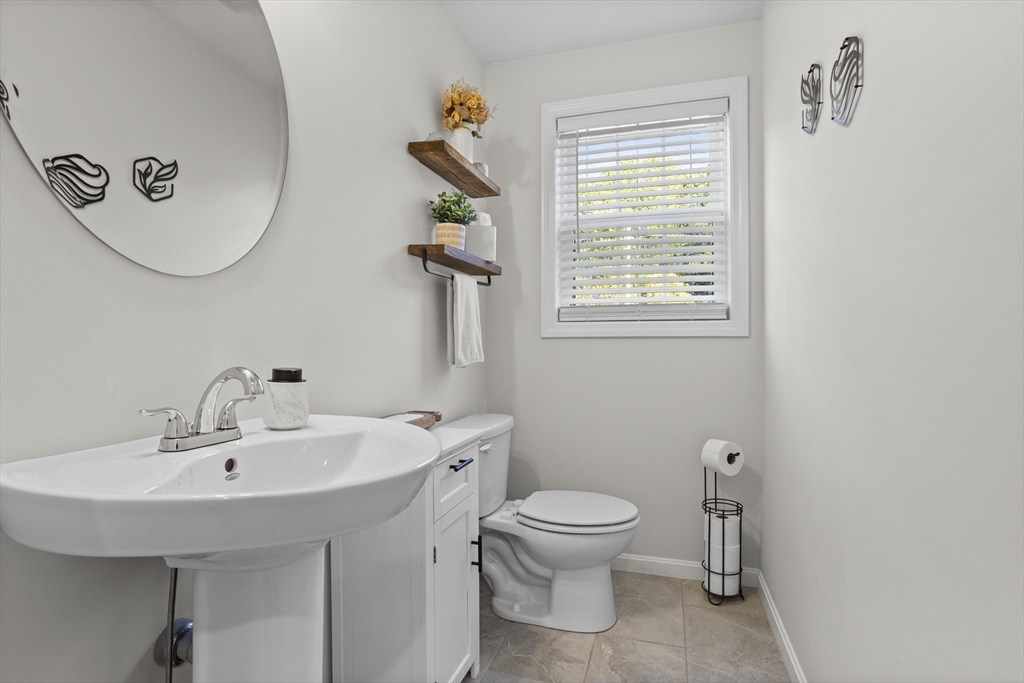 45 Riley Road, Unit 45 Tyngsborough, MA 01879 - Photo 15 of 42 a bathroom with a toilet sink and mirror