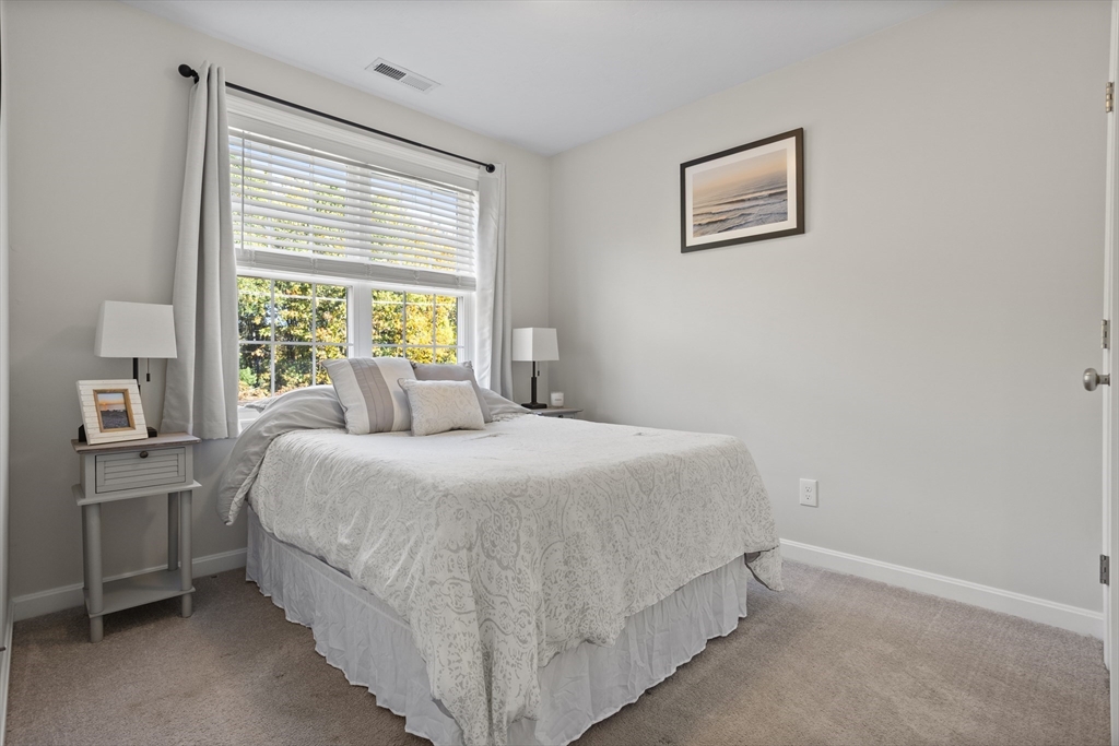 45 Riley Road, Unit 45 Tyngsborough, MA 01879 - Photo 17 of 42 a bedroom with a bed and a window