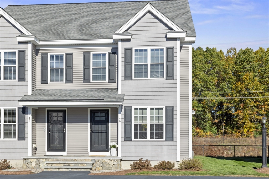 45 Riley Road, Unit 45 Tyngsborough, MA 01879 - Photo 2 of 42 a front view of a house with a yard