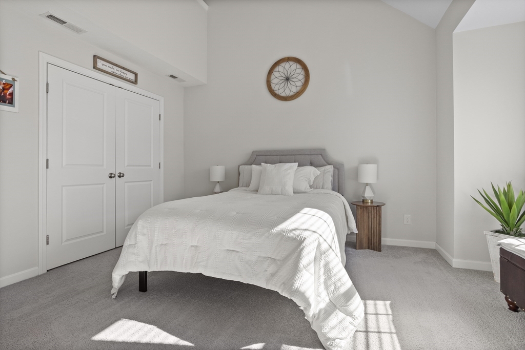 45 Riley Road, Unit 45 Tyngsborough, MA 01879 - Photo 23 of 42 a bedroom with a bed and a potted plant