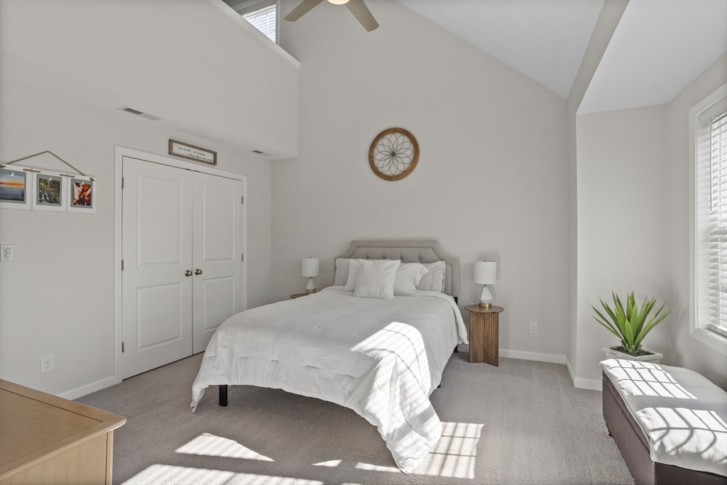 45 Riley Road, Unit 45 Tyngsborough, MA 01879 - Photo 26 of 42 a bedroom with a bed and a potted plant