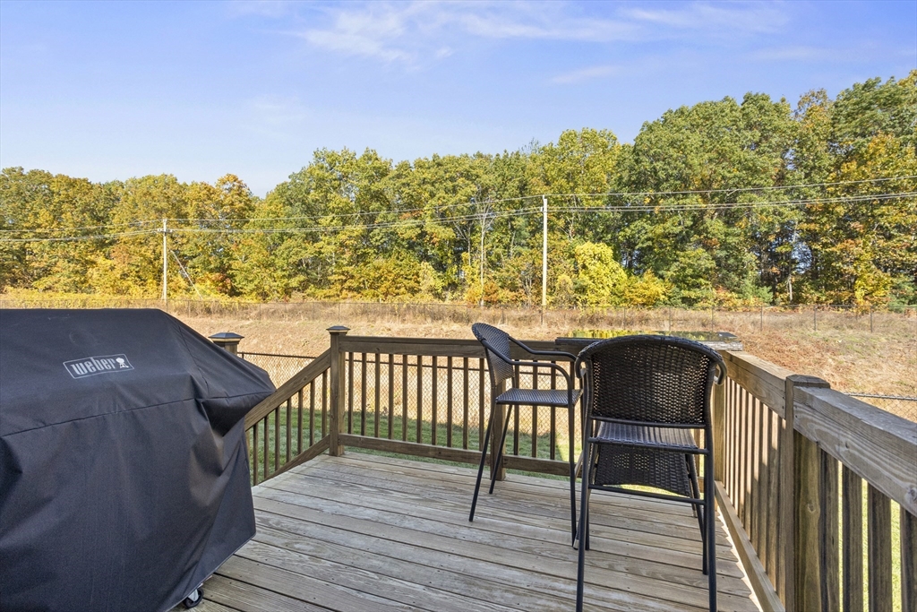 45 Riley Road, Unit 45 Tyngsborough, MA 01879 - Photo 34 of 42 a balcony with table and chairs
