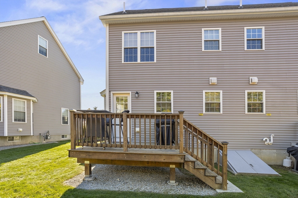 45 Riley Road, Unit 45 Tyngsborough, MA 01879 - Photo 36 of 42 a view of deck with a chair and floor to ceiling window